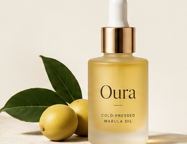 Oura cold-pressed marula oil in a frosted dropper bottle with citrus fruit and leaves